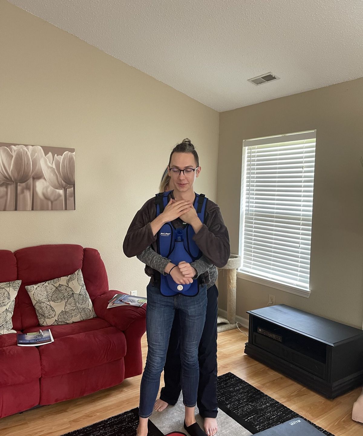 Practicing abdominal thrusts with a choking rescue training vest