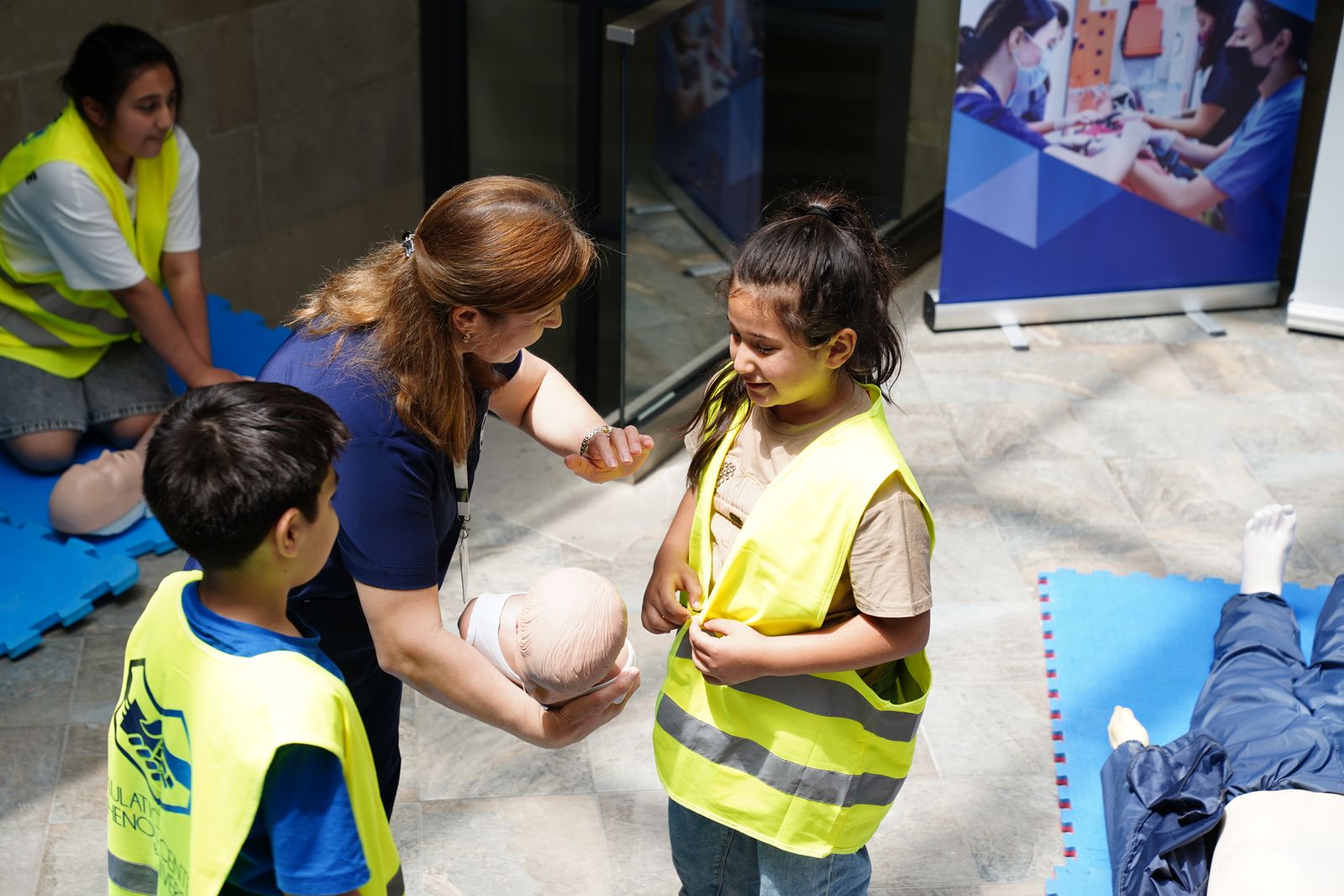 An instructor teaching CPR technique to a small group