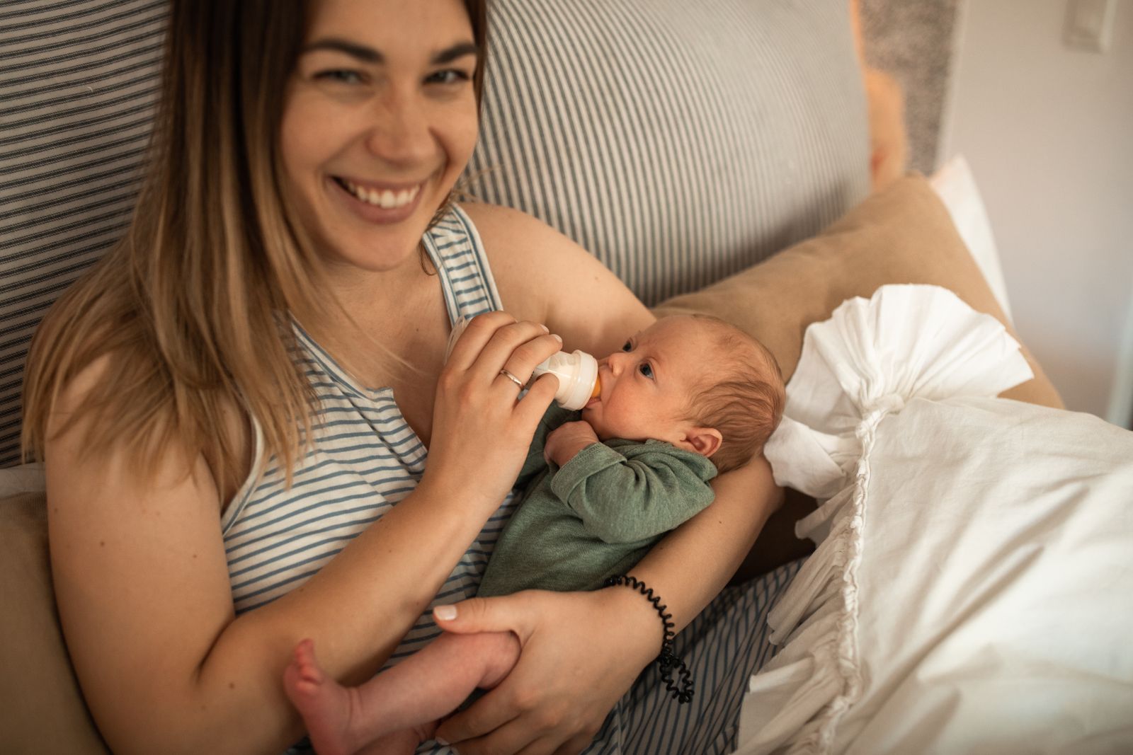 A mother feeding her newborn at home
