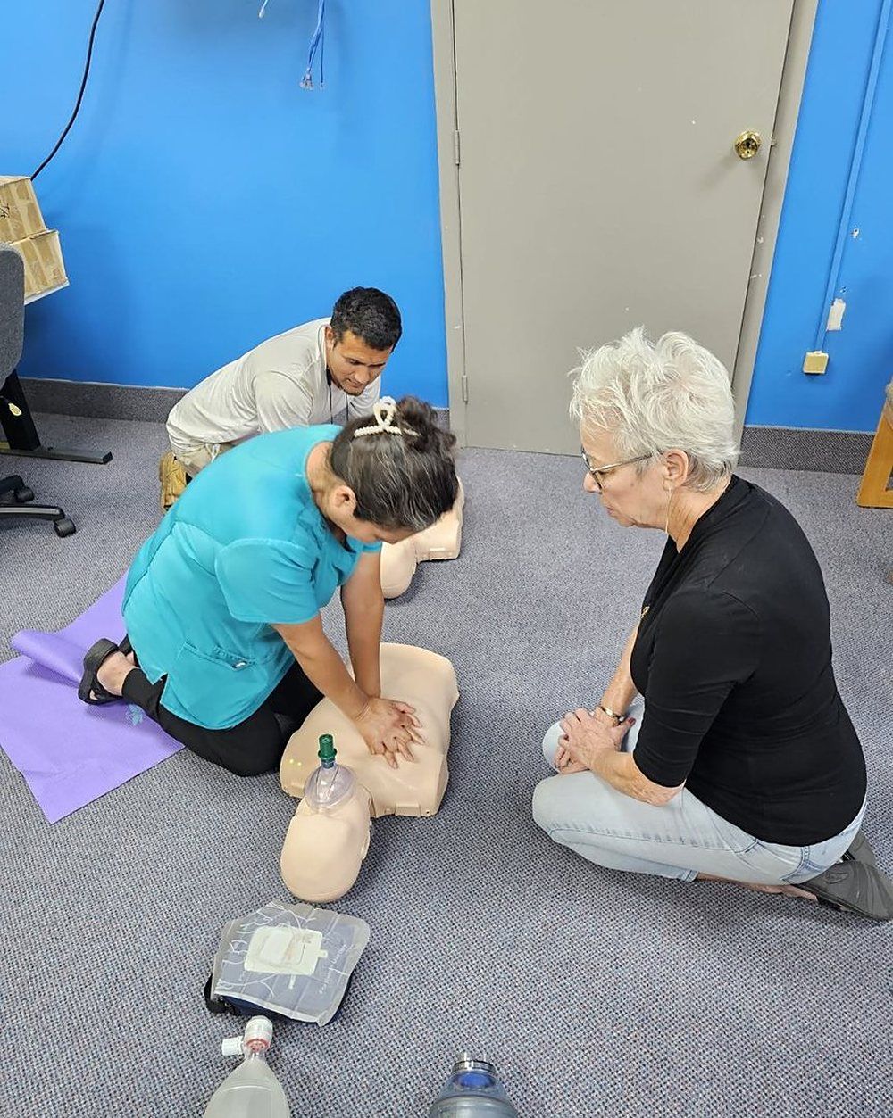 Pam Goldsberry coaching a student through chest compressions