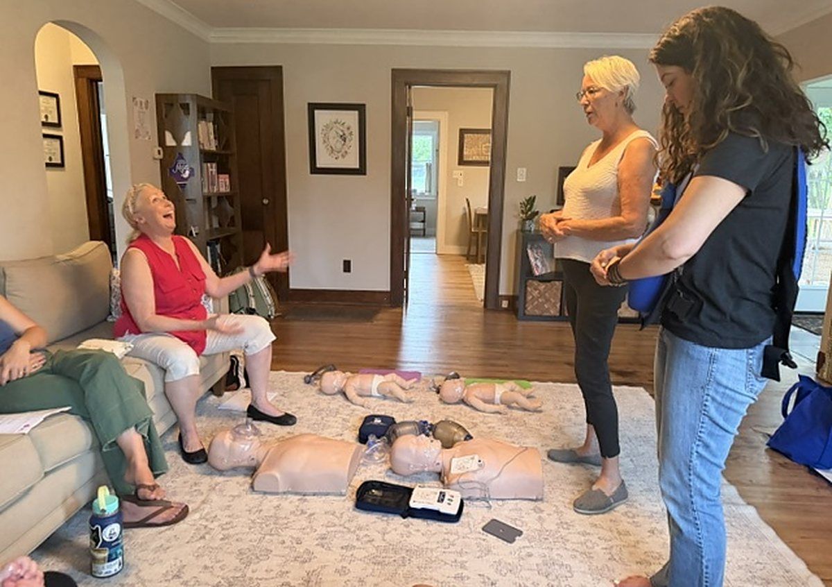 Pam Goldsberry talking with guests during an in home CPR class