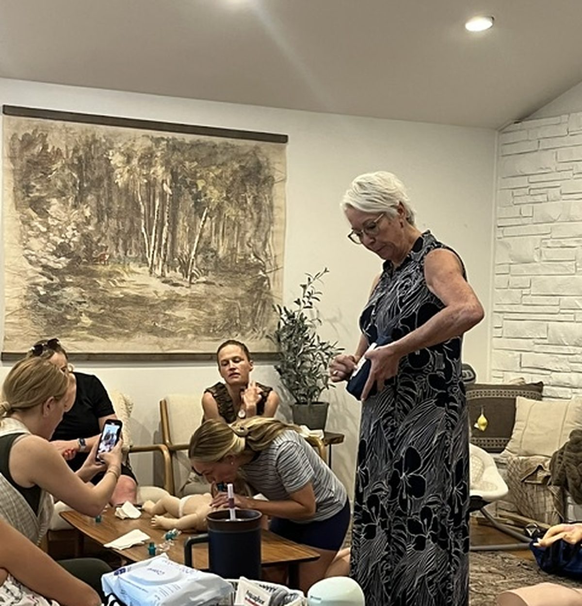 Pam Goldsberry, RN, teaching a CPR party in a client's living room