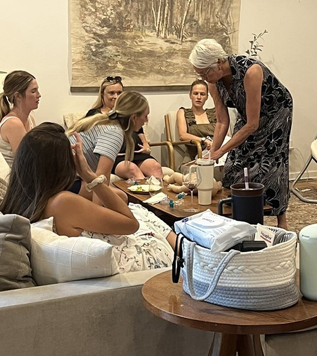 Guests seated around infant manikins during a Tiny Hearts CPR party